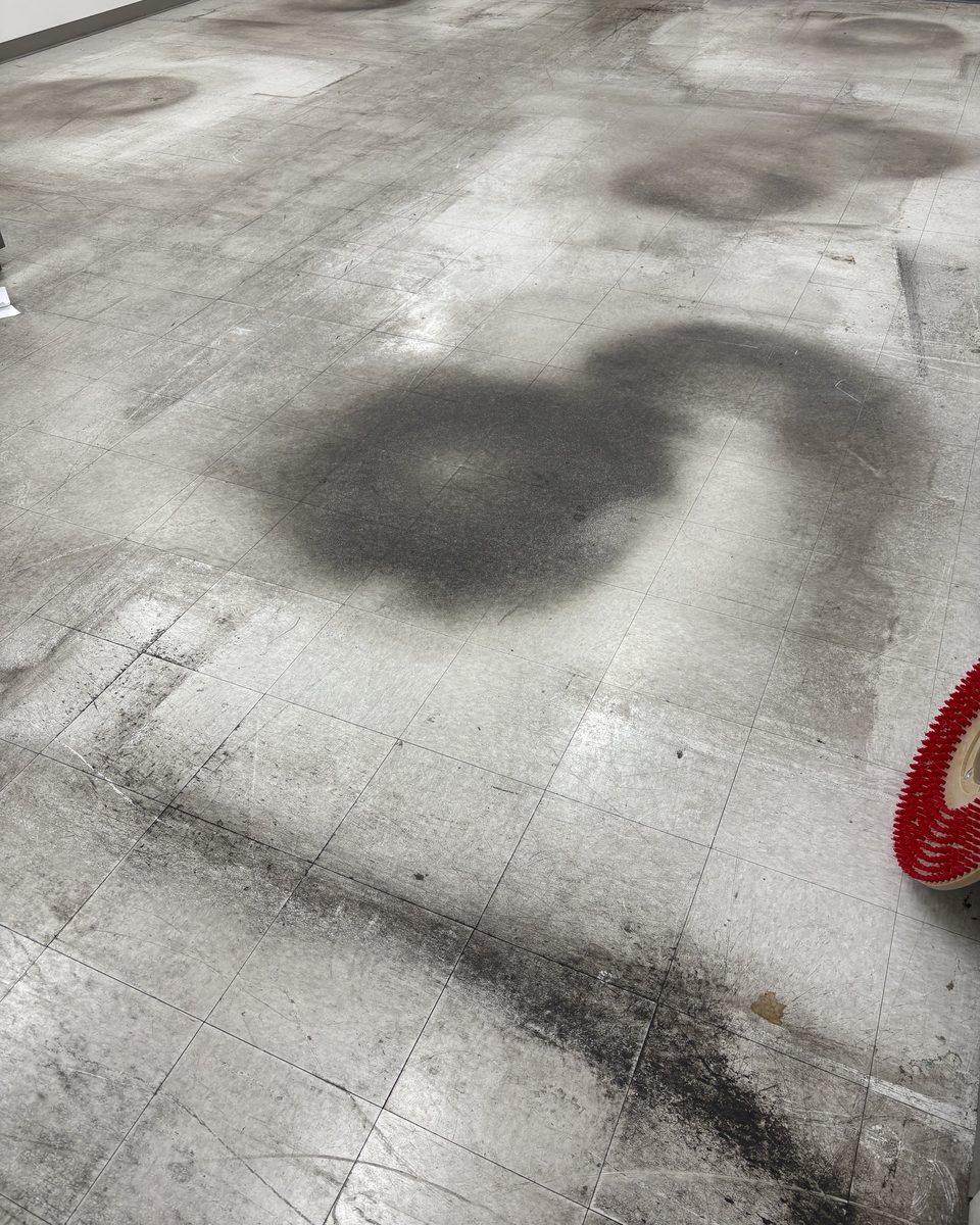 Worn, stained VCT tile floor before Patriot Pro Cleaning restored it