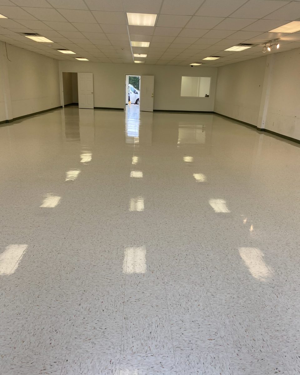 Long open room with a freshly finished, shining tile floor